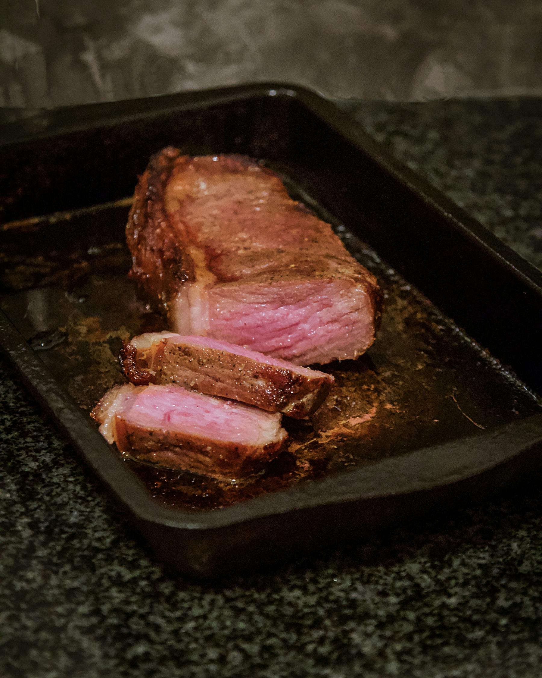 a close up of a piece of meat on a cutting board