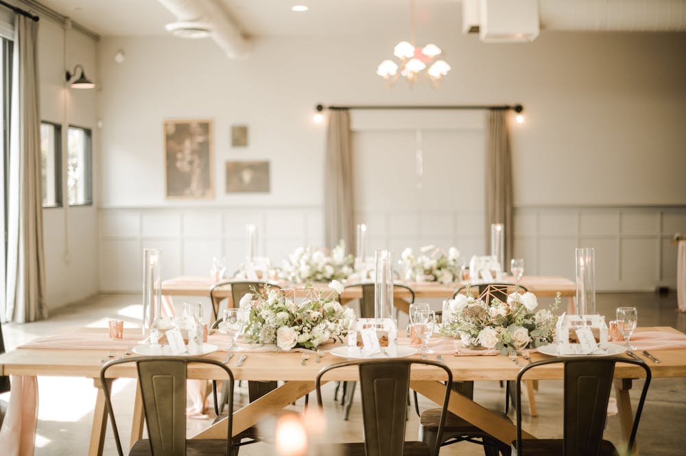 a room filled with furniture and vase of flowers on a table