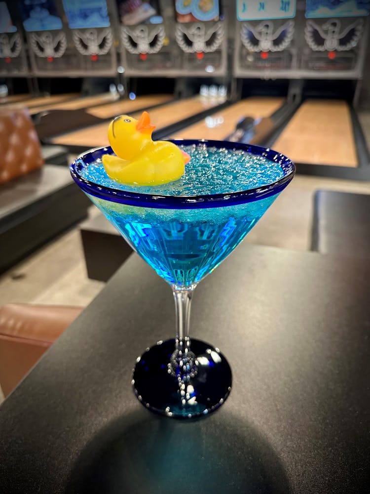 a glass with a blue bowl on a table