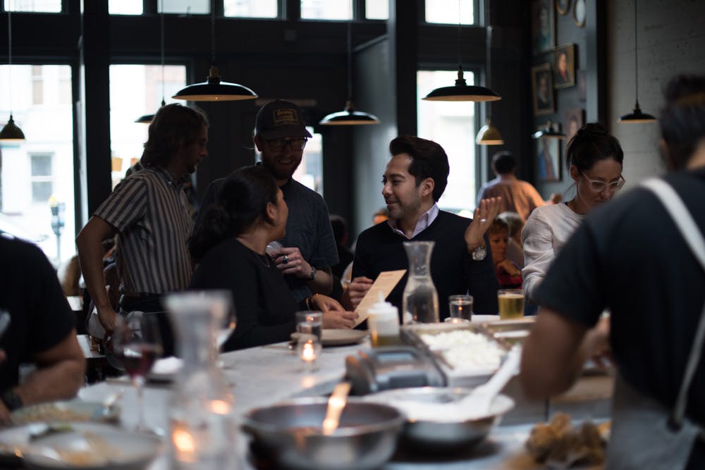 a group of people sitting at a table with wine glasses