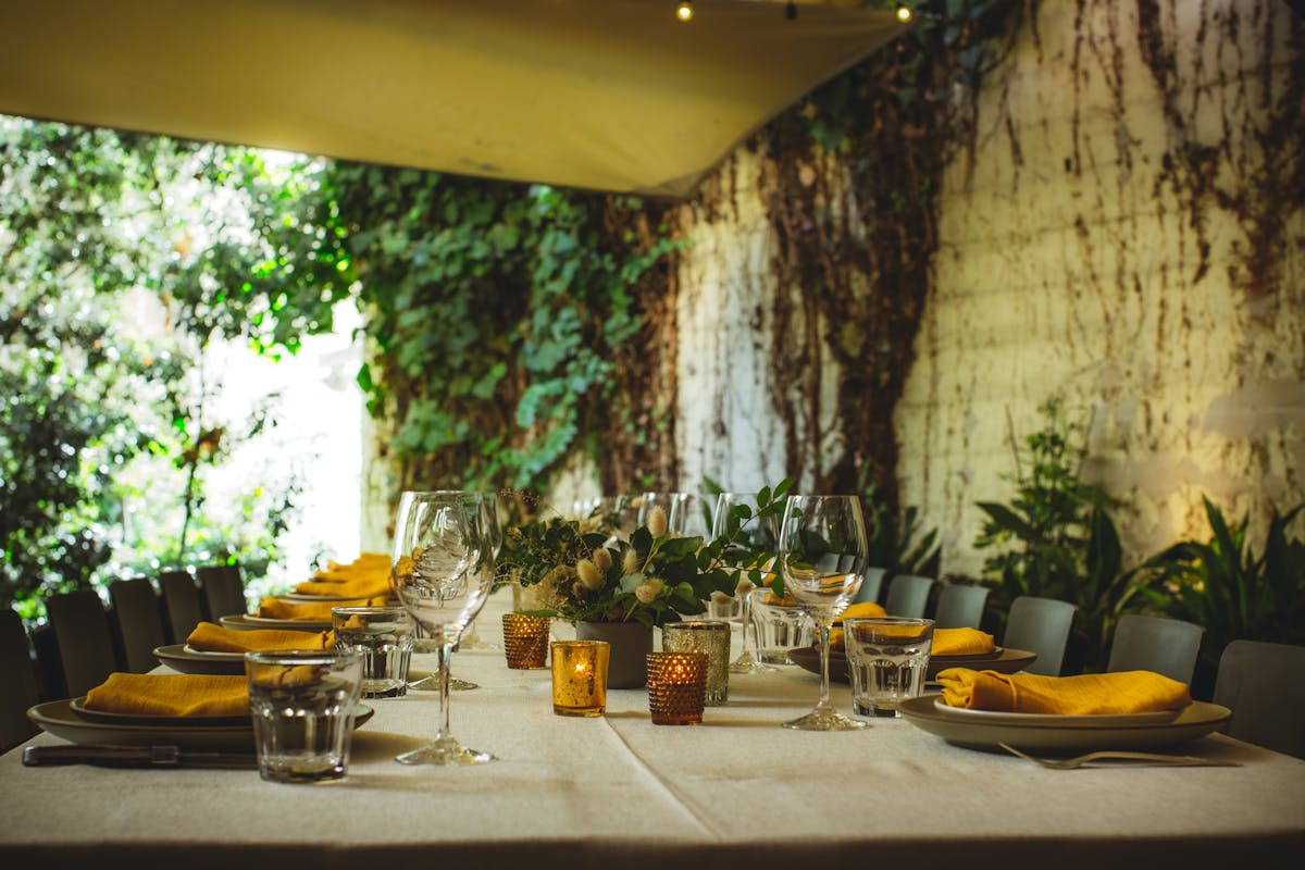 a large table decorated with yellow napkins over the plates