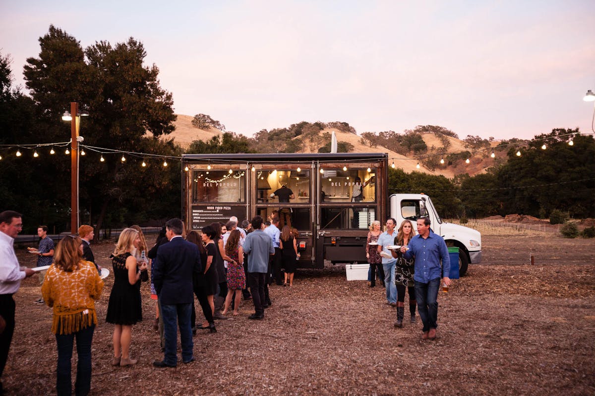 people making a line to buy food on the food truck