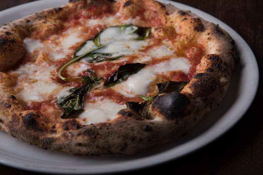 a close up of a slice of pizza on a plate
