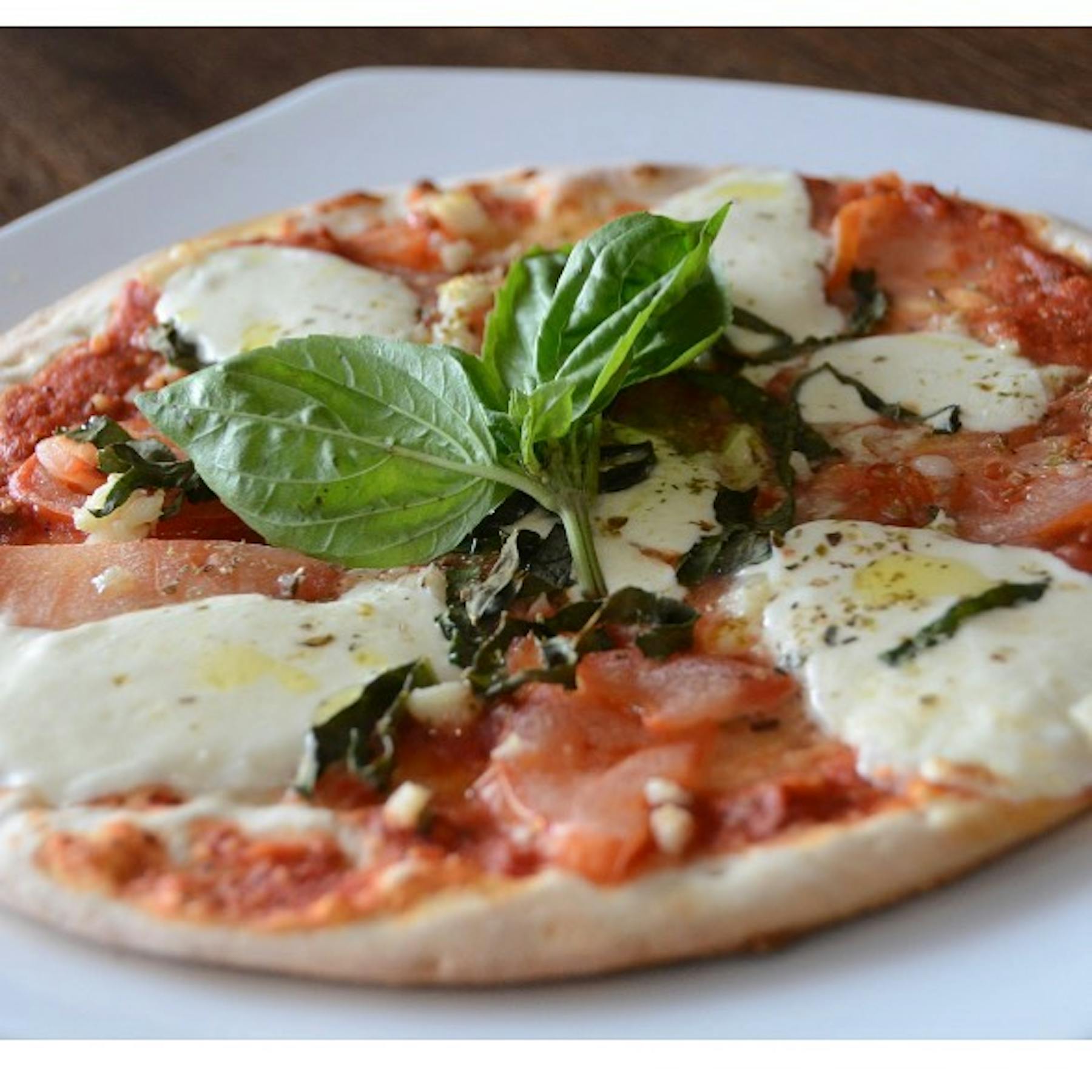 a close up of a plate of food with a slice of pizza