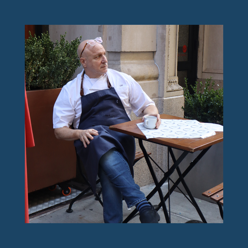 Tom Colicchio sitting on a bench
