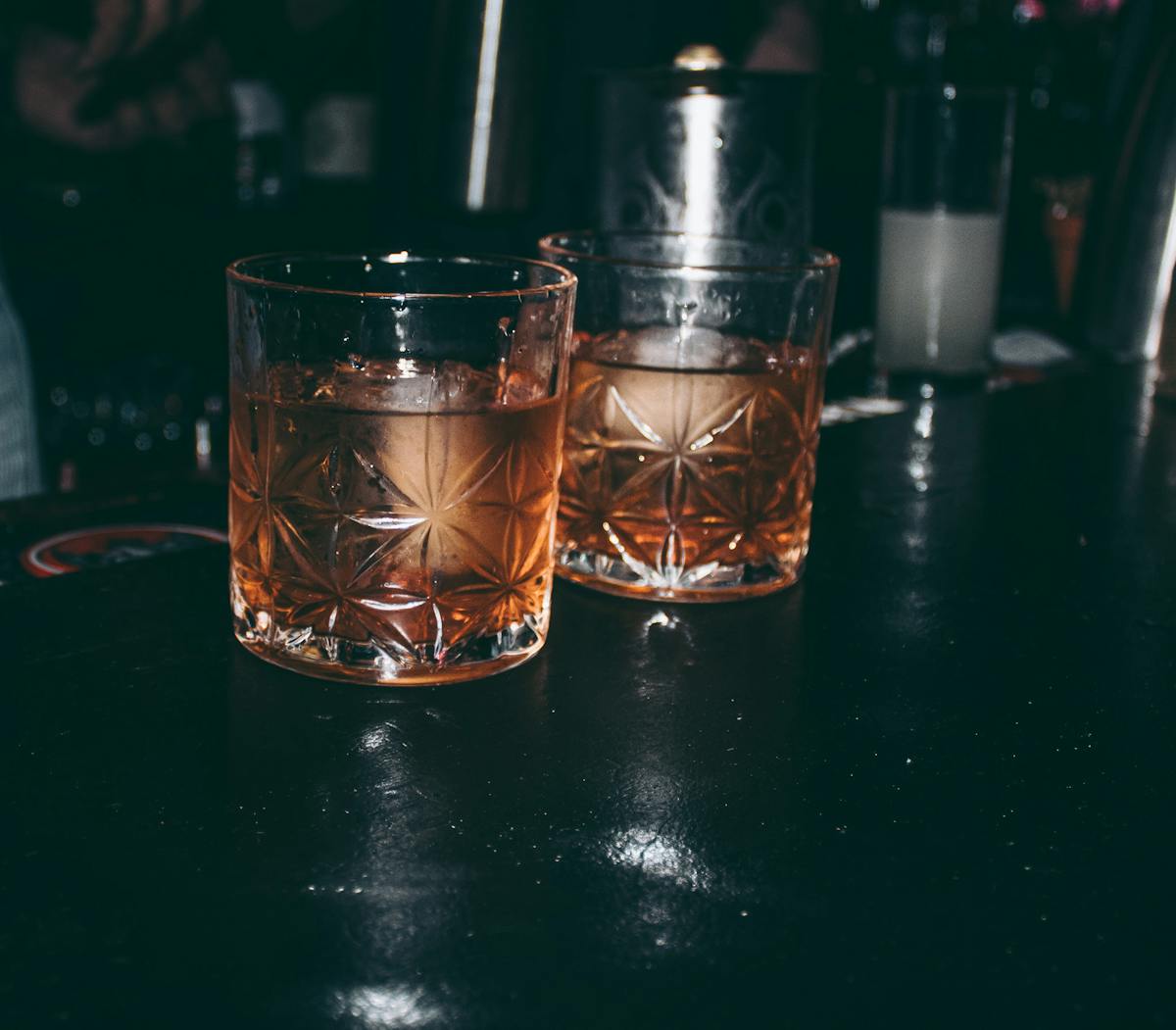 a glass of wine sitting on top of a wooden table