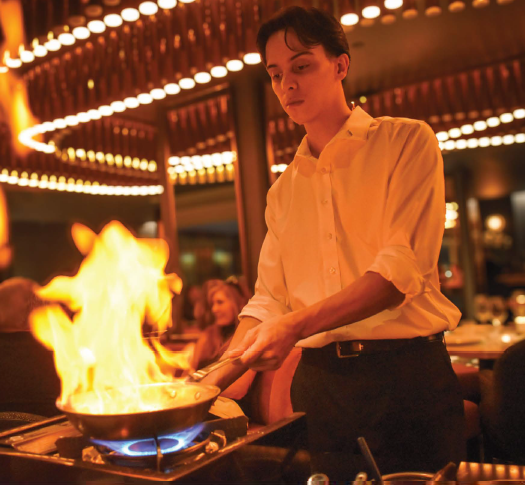 a person cooking over a fire