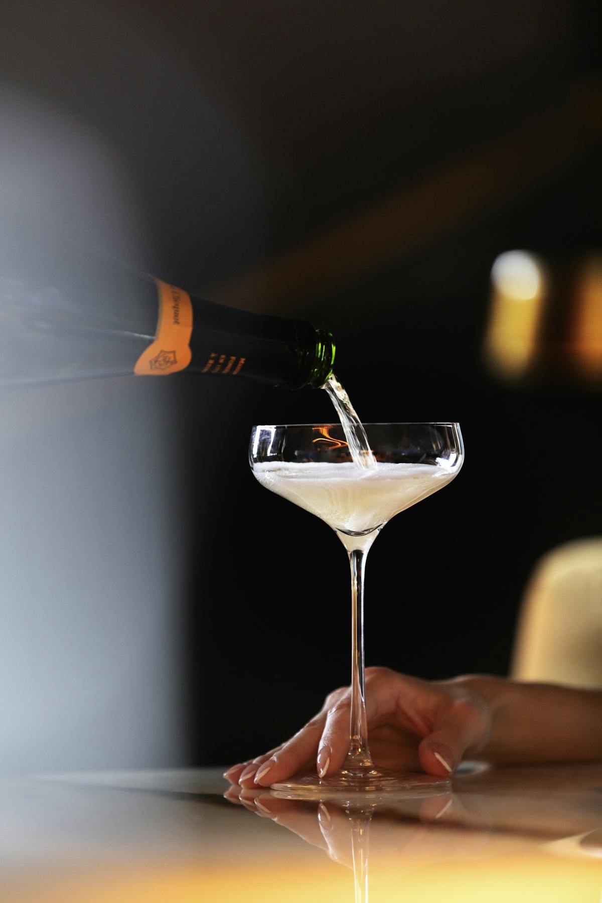 a glass of champagne getting filled up
