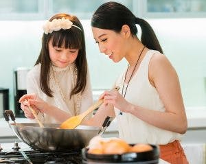 a woman preparing food in a kitchen