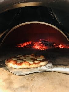 a pizza sitting on top of a stove