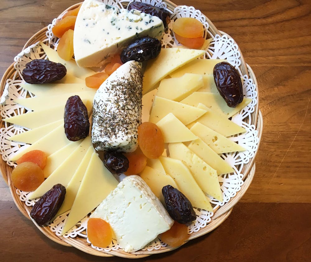 a plate of cheese presented on a platter.