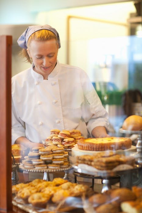 a woman preparing food in a kitchen