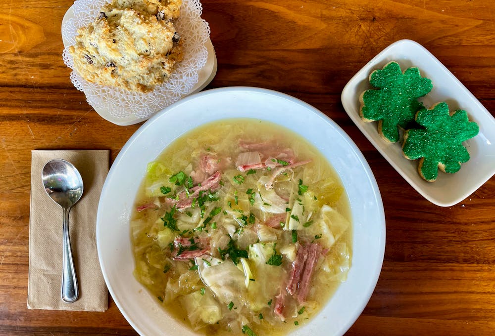 a bowl of food sitting on top of a wooden table