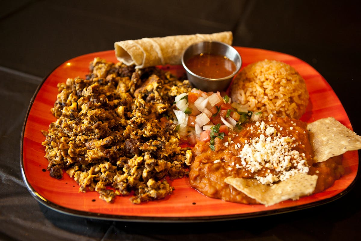 a plate of food with rice meat and vegetables