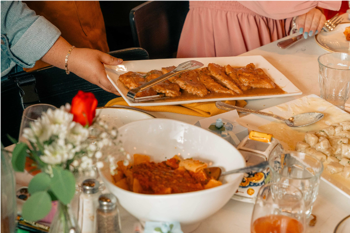 a person sitting at a table with a plate of food