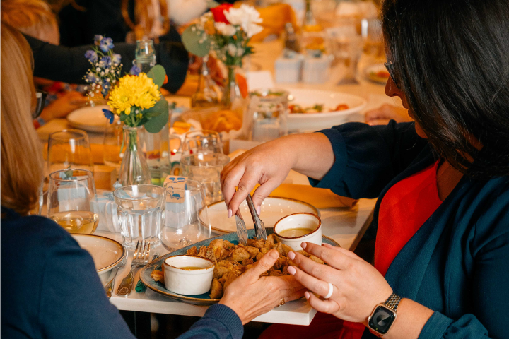 a group of people sitting at a table eating food