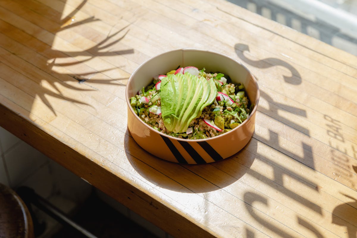a bowl of broccoli sitting on a table