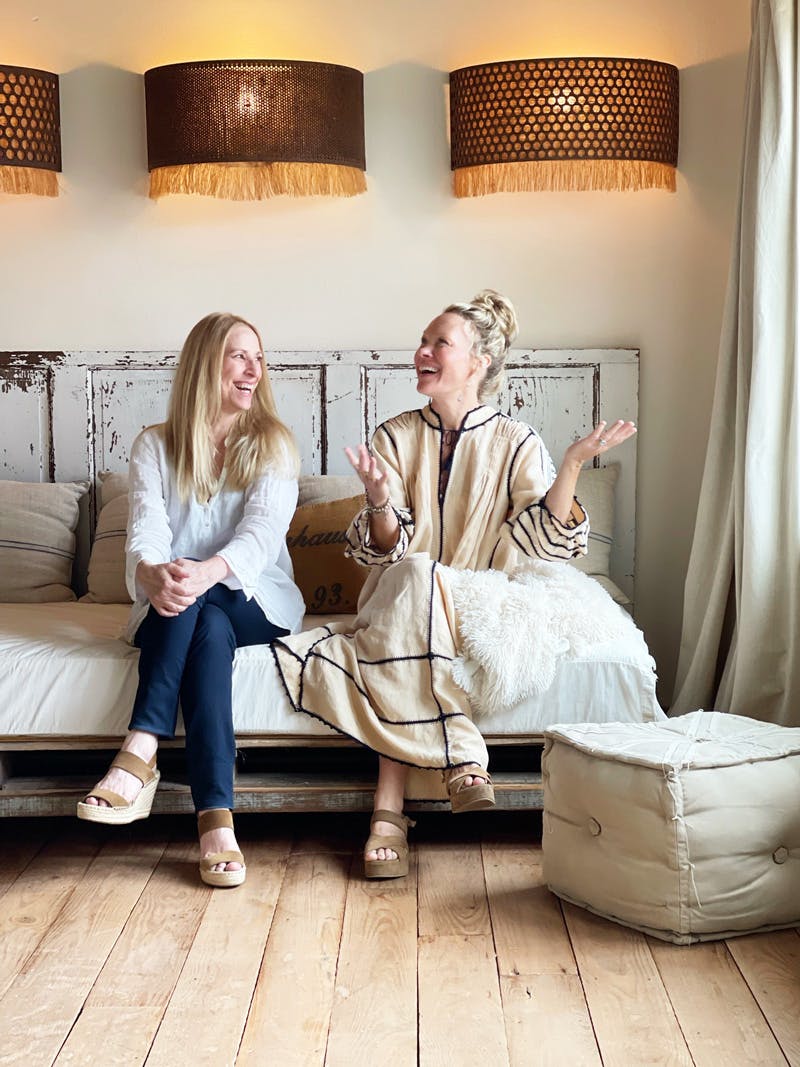 a couple of people that are sitting on a bed posing for the camera
