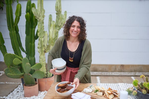 a woman sitting at a table with a plate of food