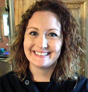 a woman smiling and wearing a chef shirt
