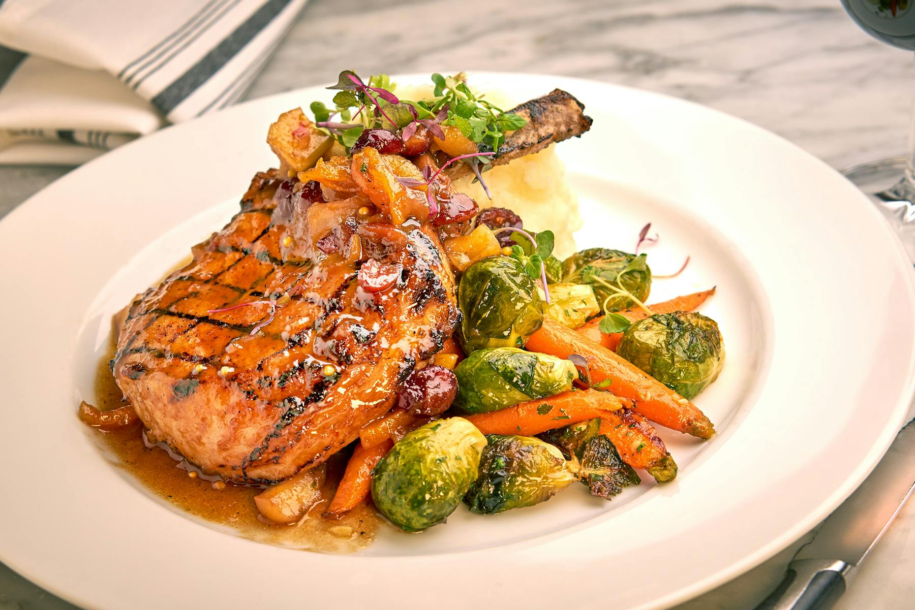 a white plate topped with meat and vegetables