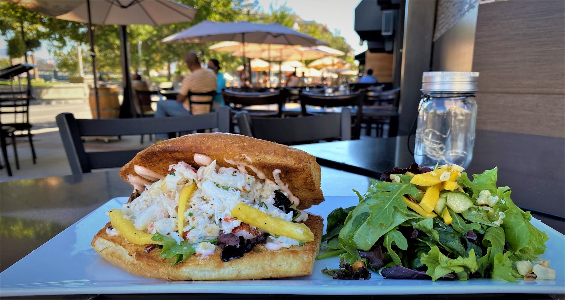 a sandwich sitting on top of a picnic table