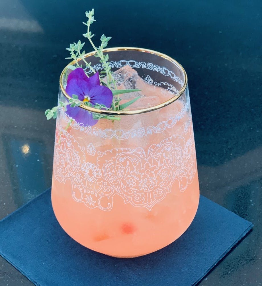 a glass with a blue vase on a table