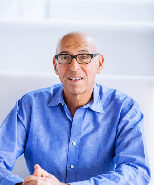 a man wearing glasses and a blue shirt