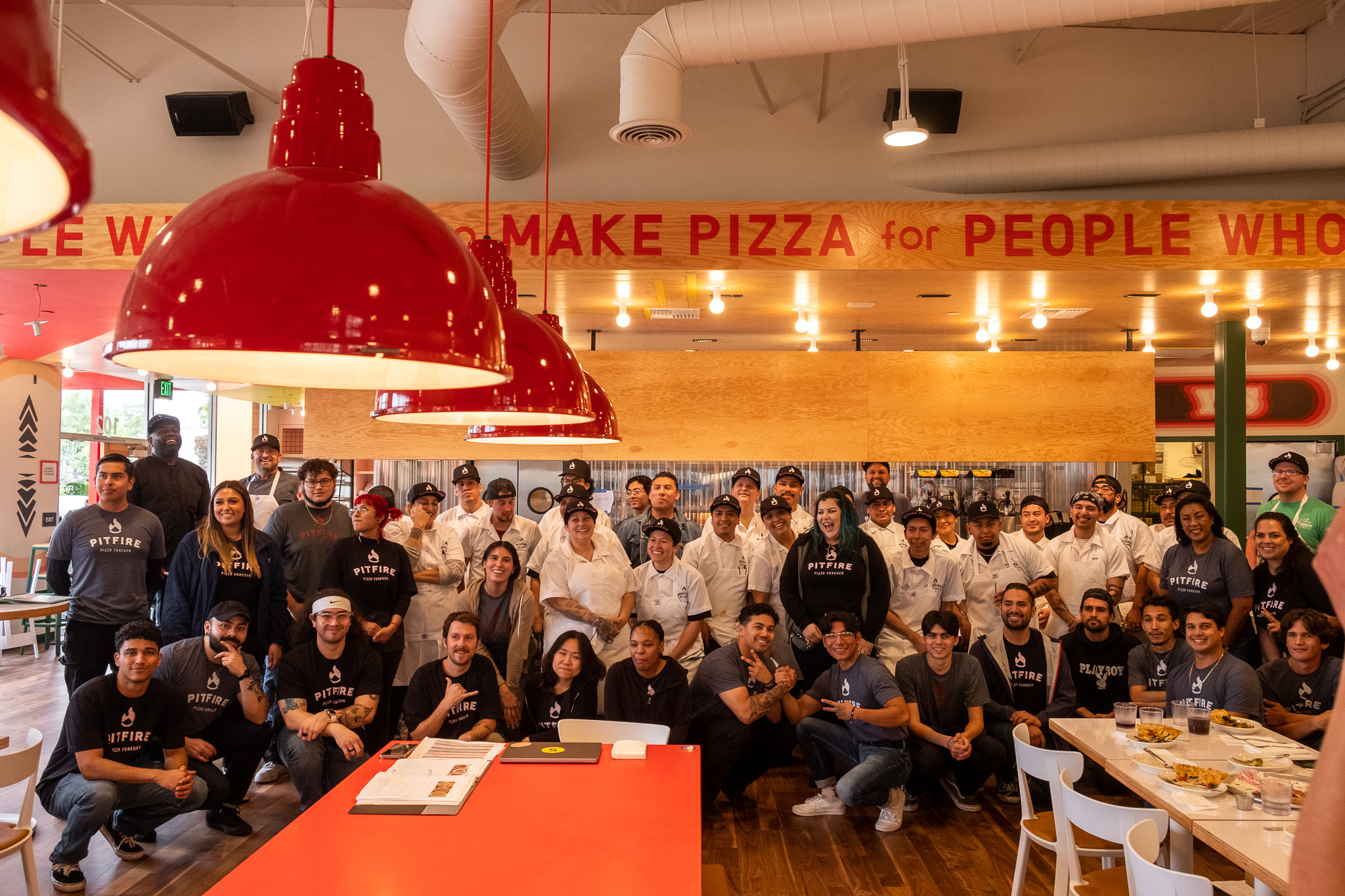 a group of people standing in front of a crowd posing for the camera