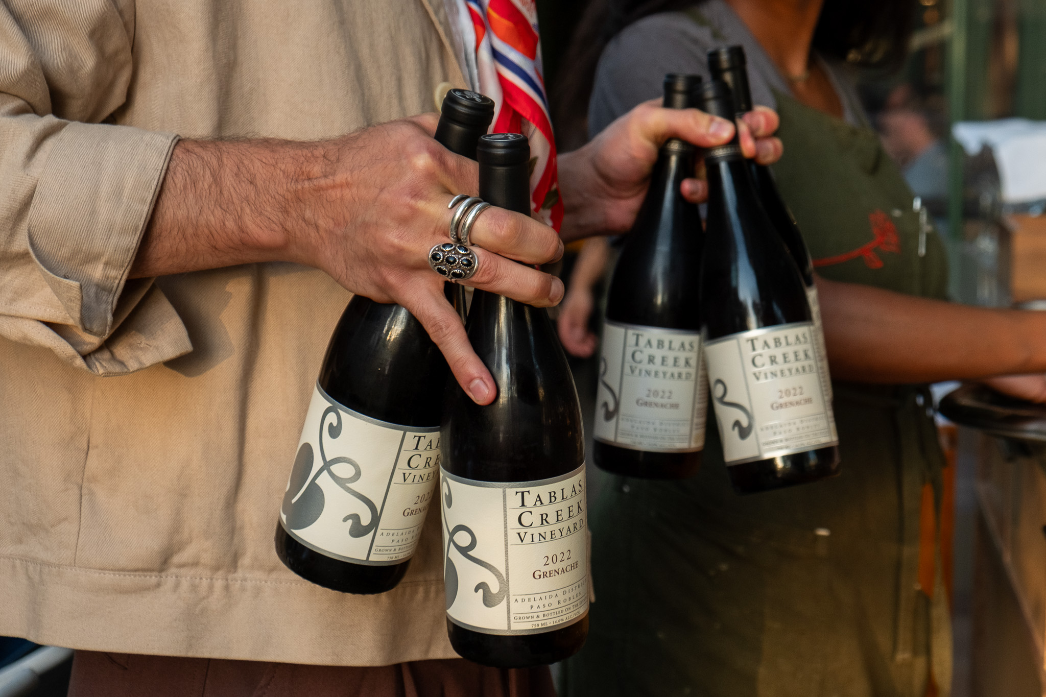 man holding wine bottles