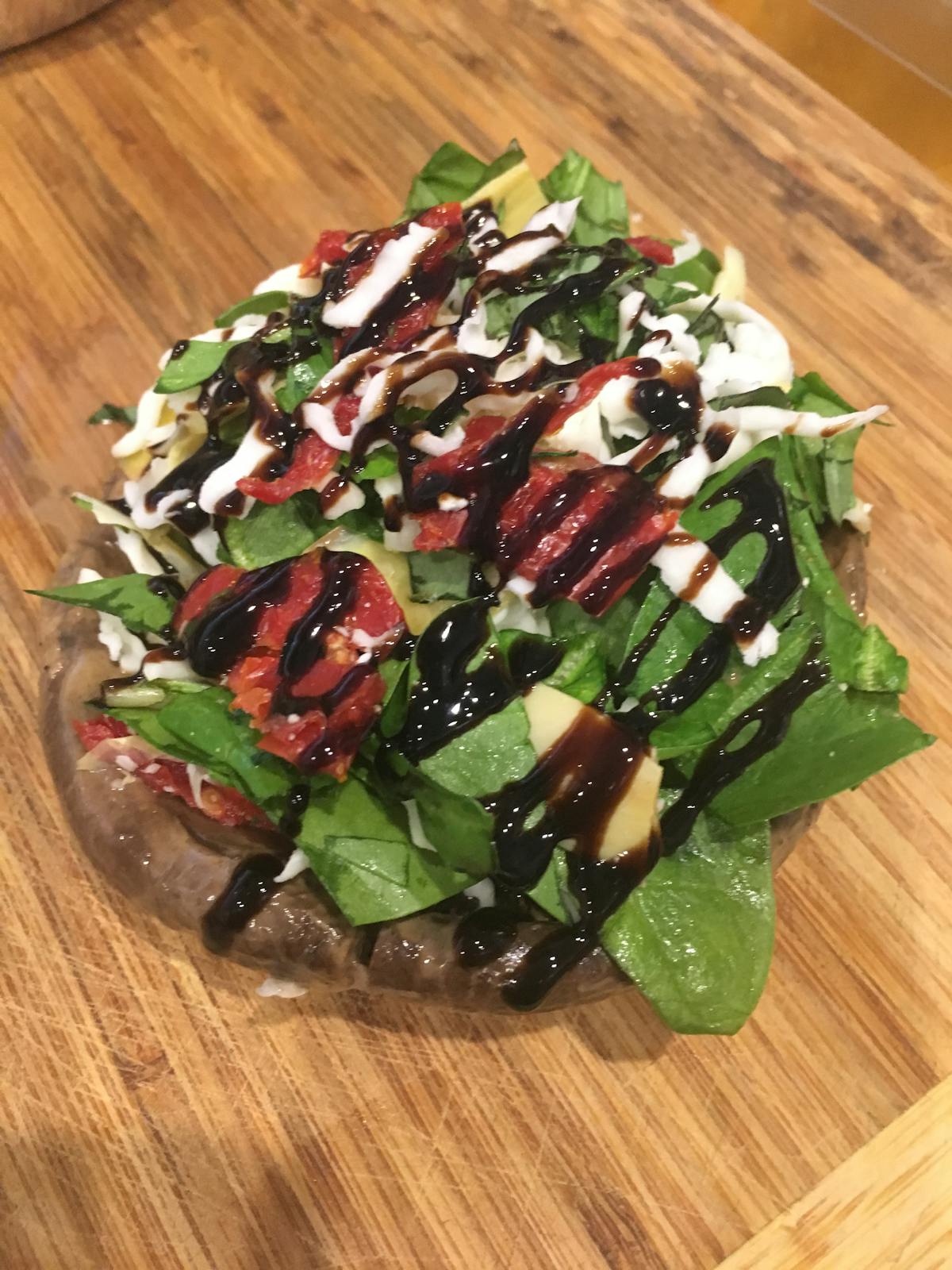 a pizza sitting on top of a wooden cutting board