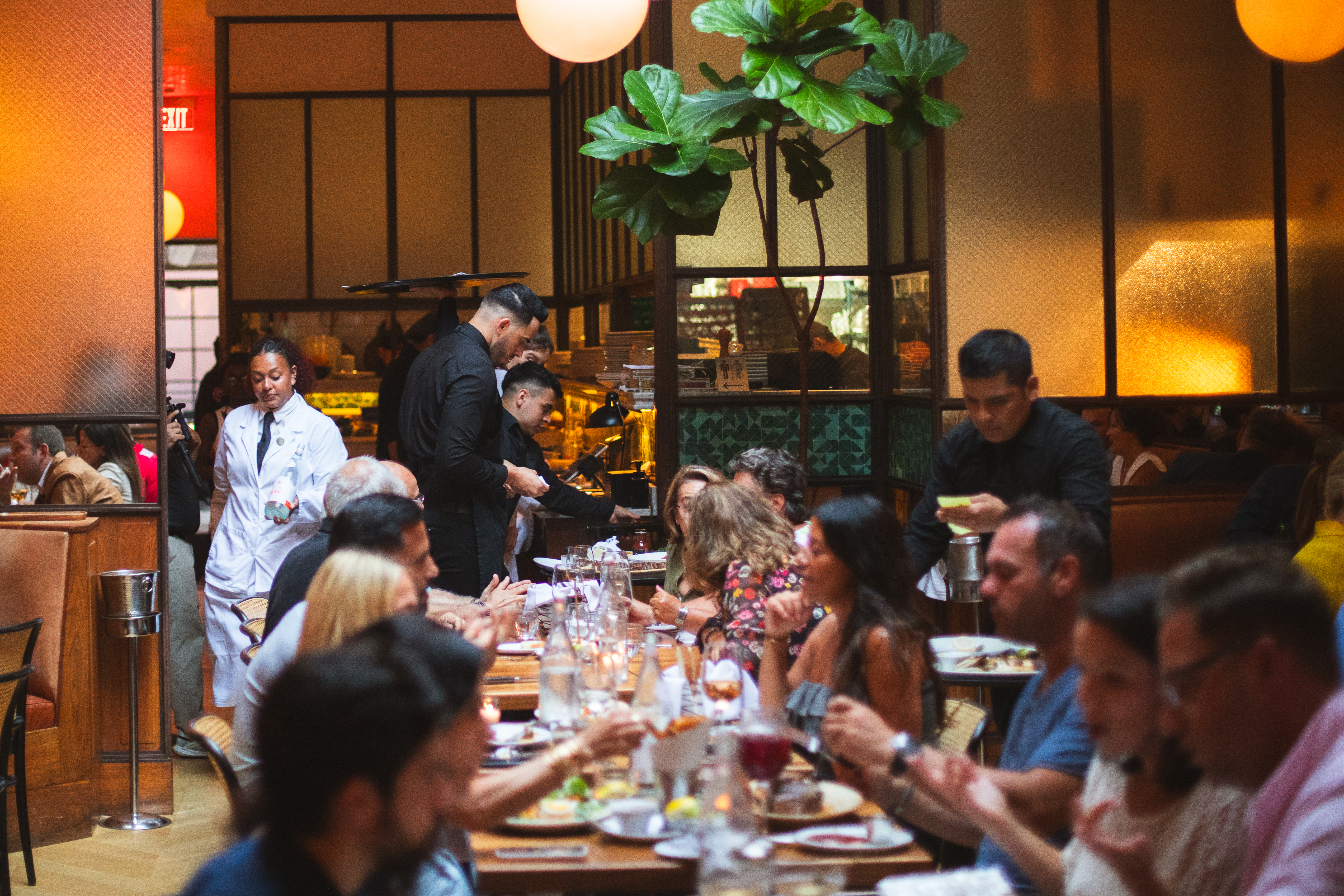 a group of people sitting at a table in a restaurant