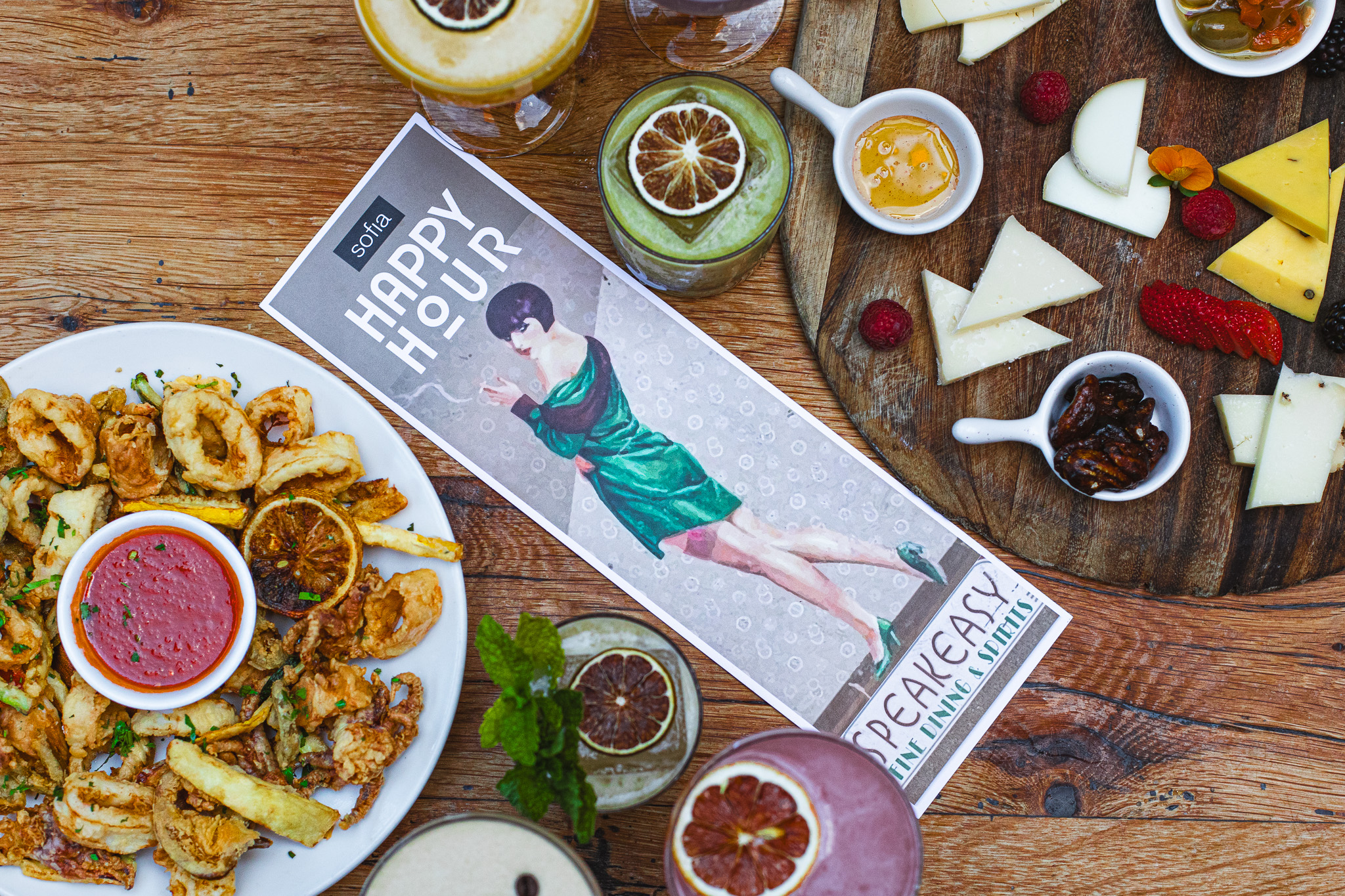 a person holding a glass of beer on a table