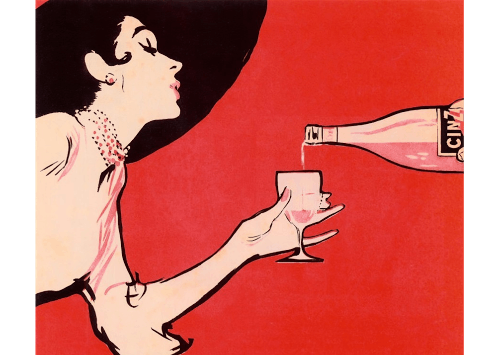 a person holding a glass of beer on a table