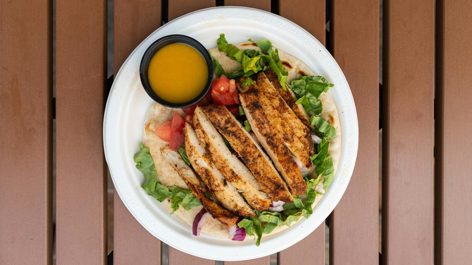 a chicken sandwich and salad on a plate