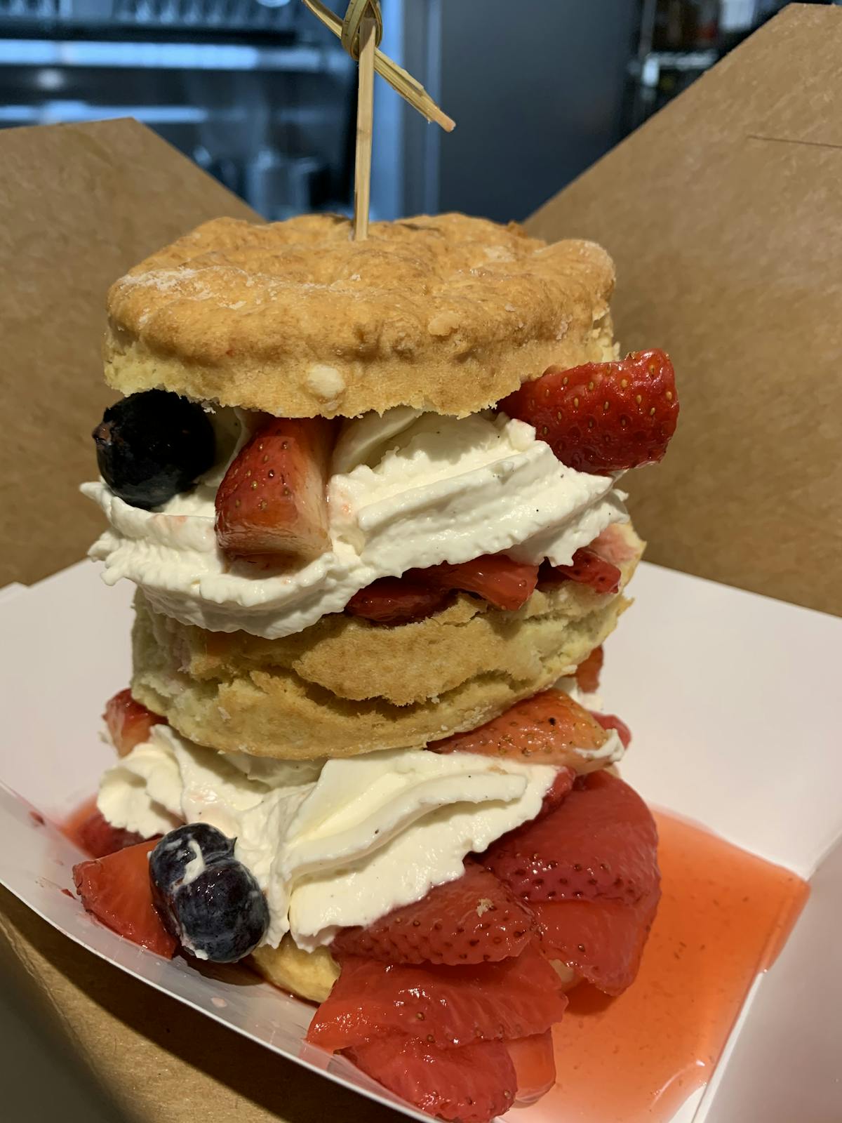a sandwich sitting on top of a piece of cake on a plate