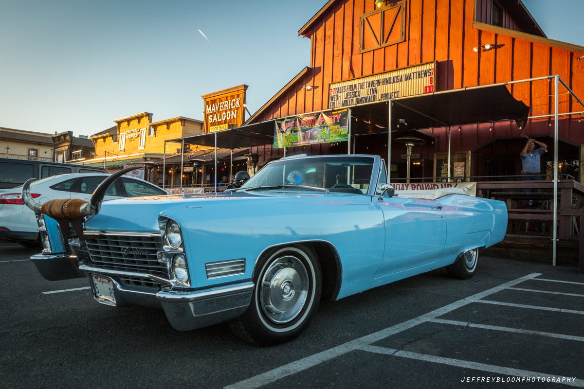 a blue car parked in front of a building