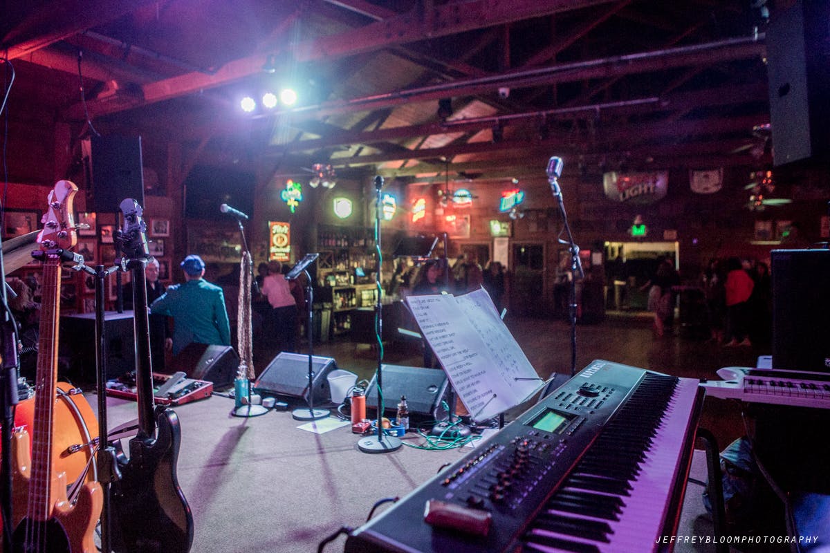 a group of people playing instruments and performing on a stage