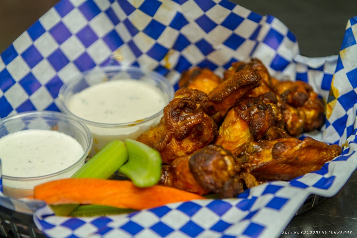 Wings, veggies and ranch dressing.