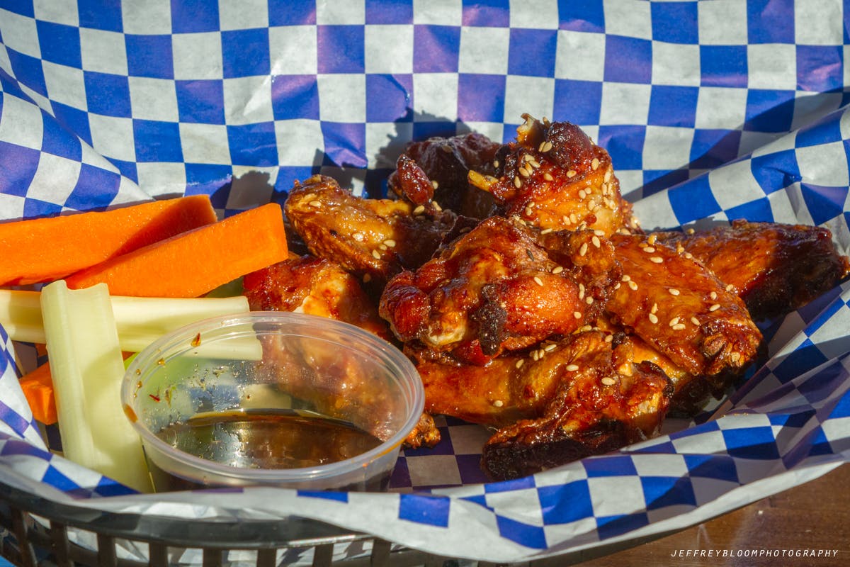 Wings, veggies and ranch dressing.