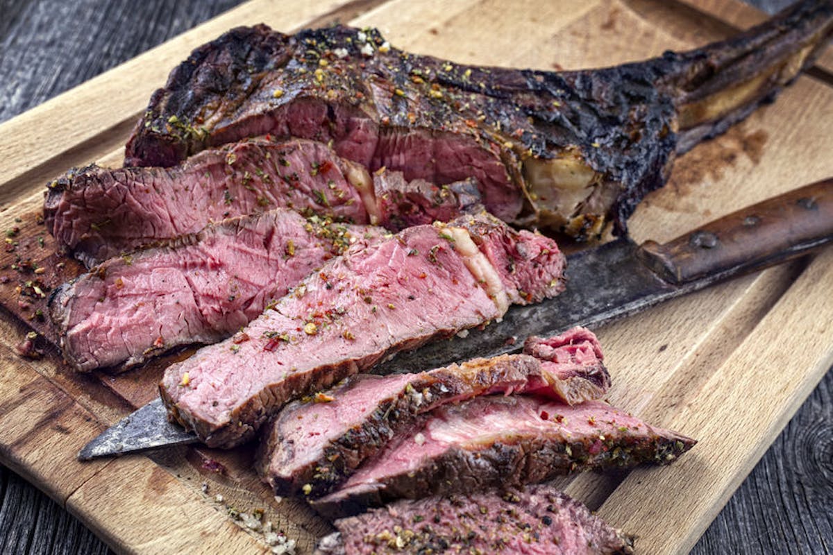 a piece of meat on a wooden cutting board