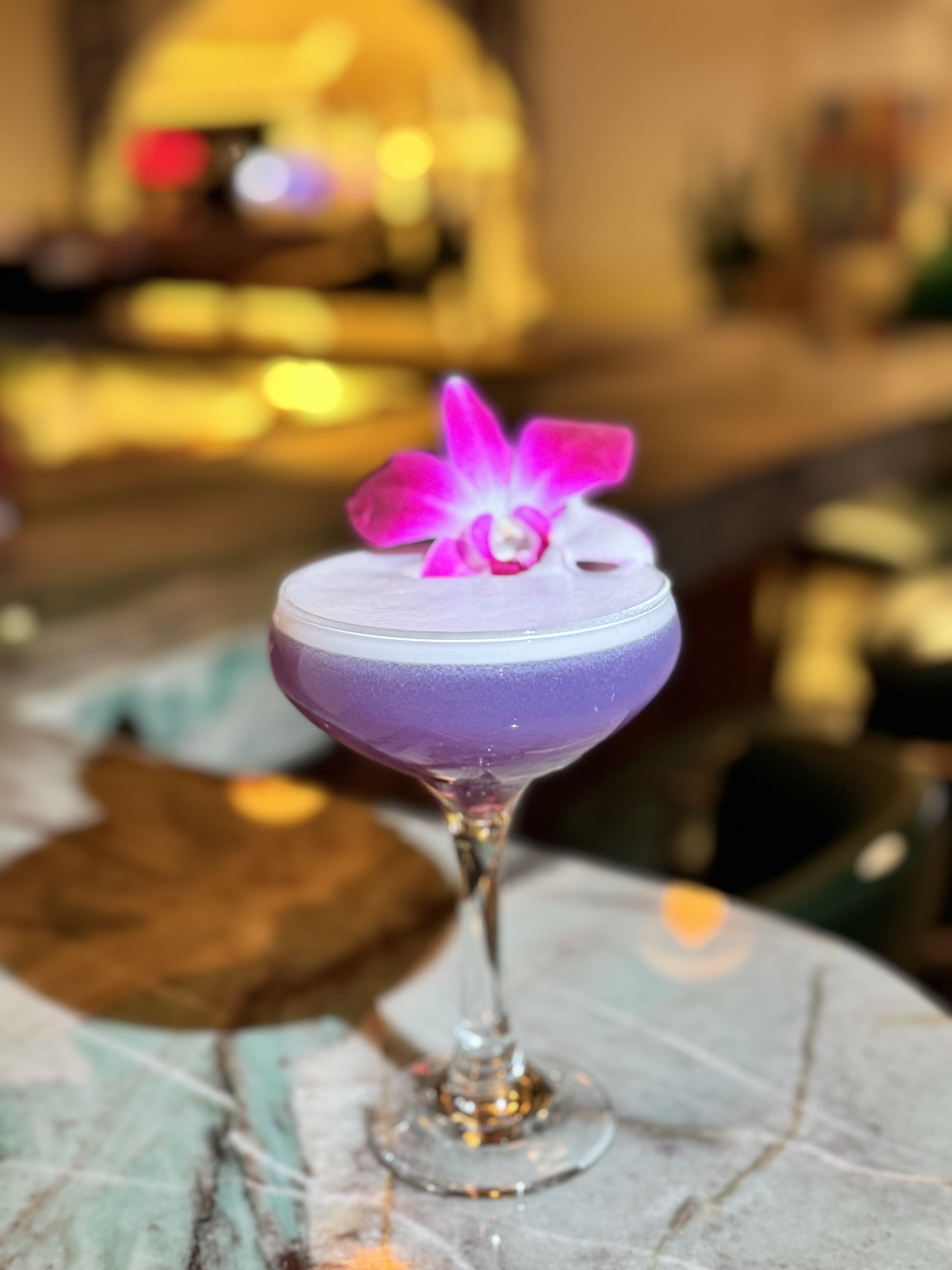 a purple drink with a flower on top of it