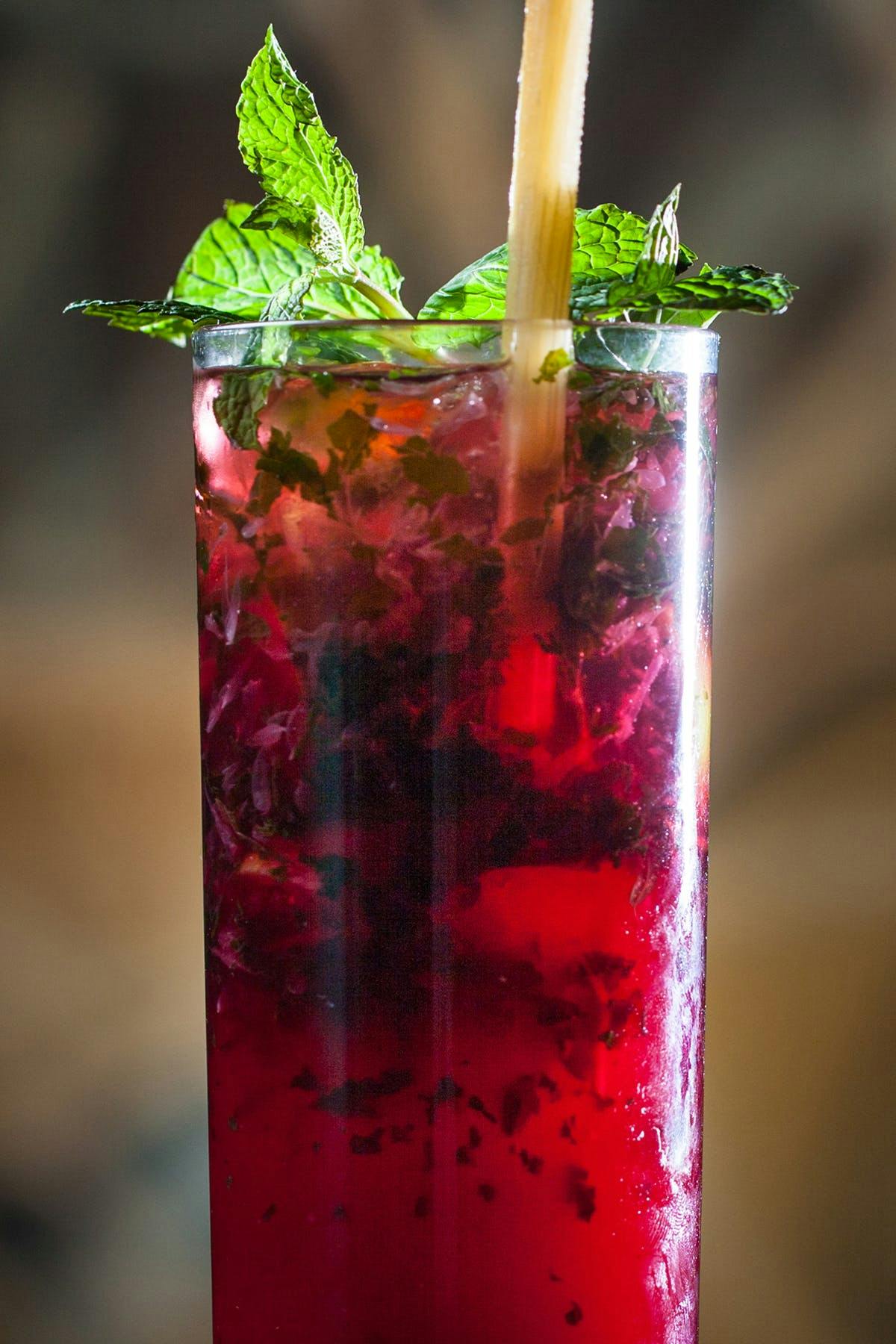 the beet mojito cocktail at SUGARCANE raw bar grill garnished with mint