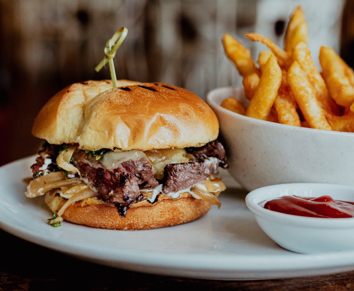 a close up of a burger and fries on a plate