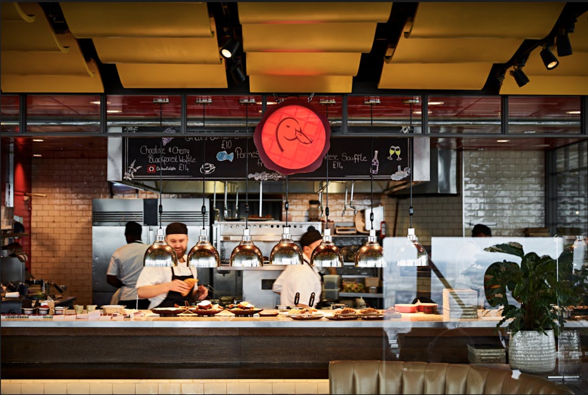 a group of chefs preparing food at Duck & Waffle London