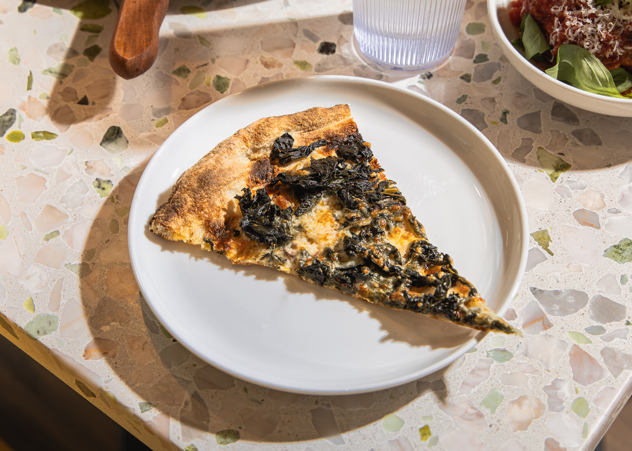 a plate of food with a slice of pizza