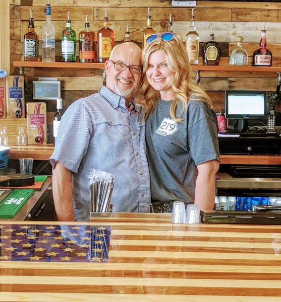 a man and a woman standing in front of a shelf