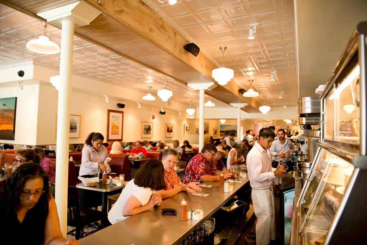 a group of people sitting at a table in a restaurant