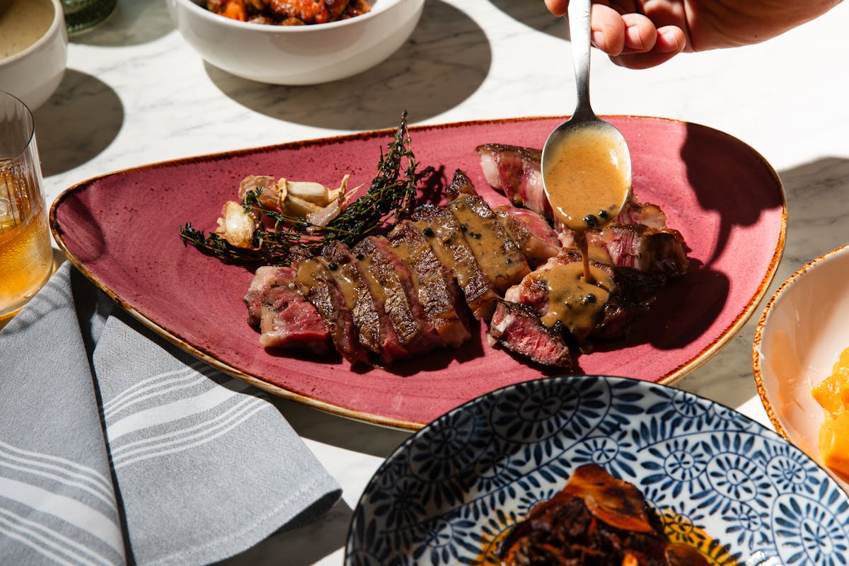 a person sitting at a table with a plate of food