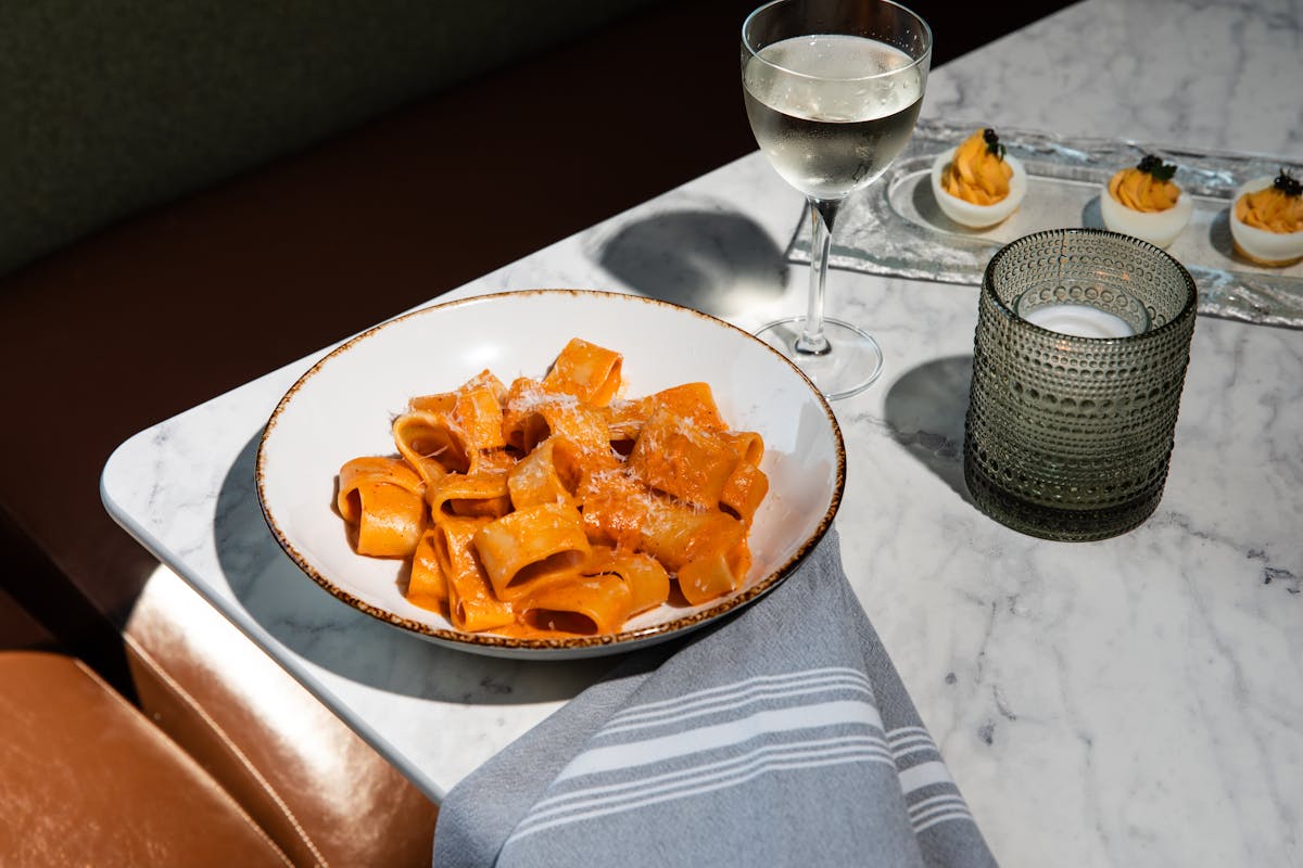 a plate of food and a glass of wine